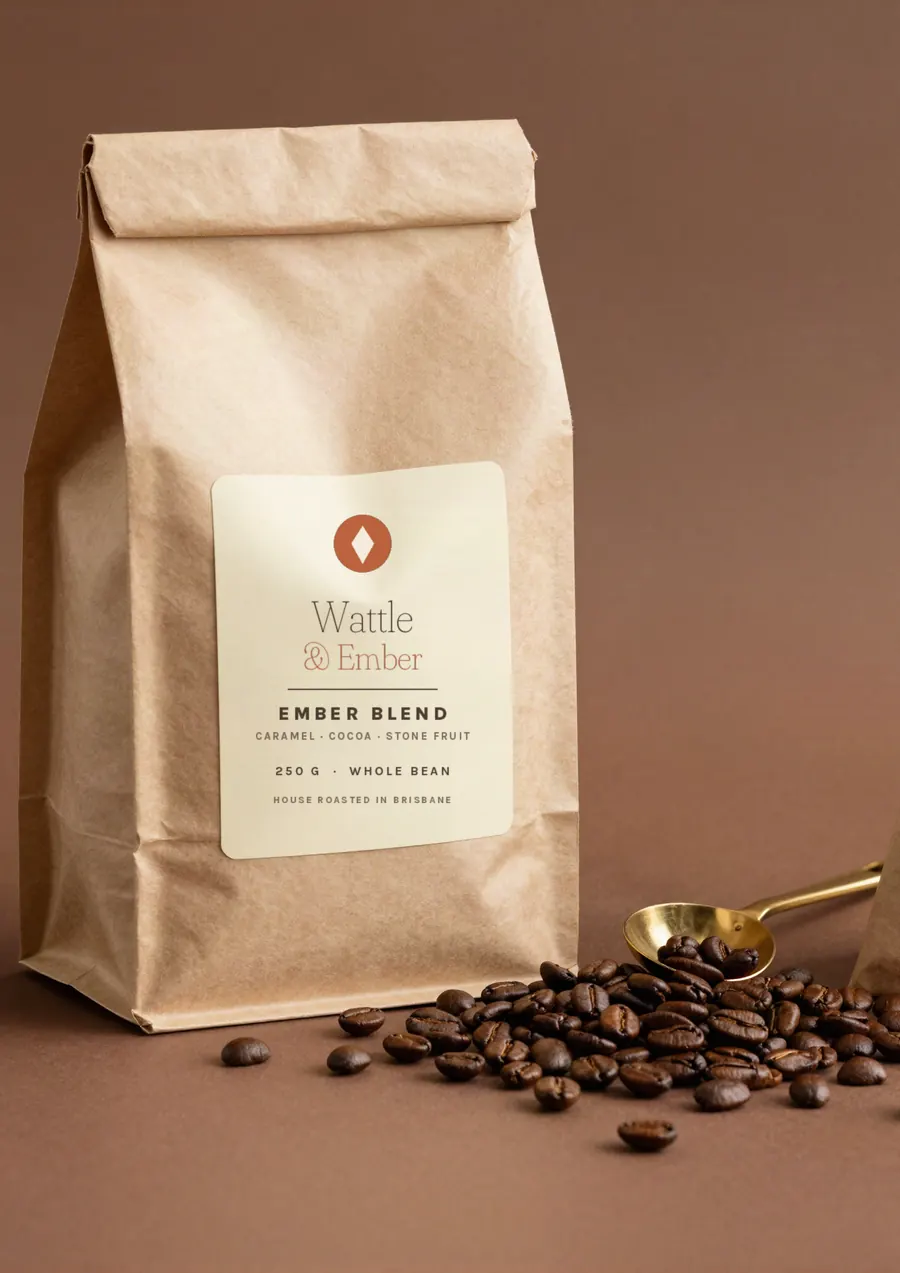 Kraft coffee bag with roasted beans and a brass scoop