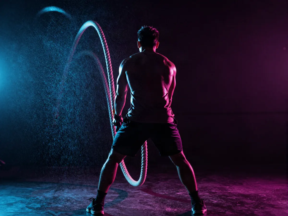 Battle ropes under pink and blue neon